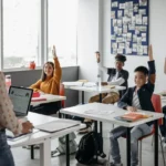 Teacher asking morning meeting questions and students answering in the classroom